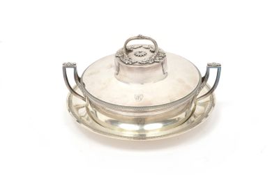 an antique silver plate with a lid and handle on a white background