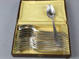 a box with a set of silver spoons in it