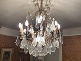 a crystal chandelier hanging from the ceiling in a living room