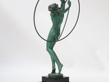 statue of a man holding a hoop in his right hand