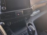 the interior of a car with a steering control and dashboard