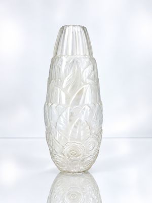 a glass vase sitting on a table with a white background