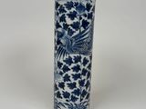 a blue and white vase with a bird on it