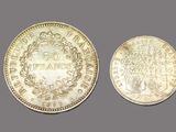 two silver coins, one with a crown and the other with a crown on it