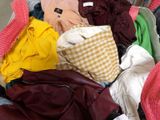 a suitcase full of clothes and clothes sitting on the floor