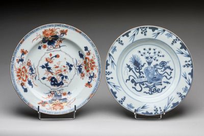pair of blue and white plates with flowers and birds on them