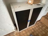 a small cabinet in the corner of a room with a box on top of it
