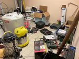 a room with a lot of electronics and tools on the floor