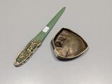 a small knife and a small metal object on a table