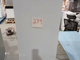a refrigerator that is sitting in the middle of a room