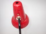a red lamp that is on a white table
