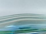 a glass bowl that has a blue and green stripe in it