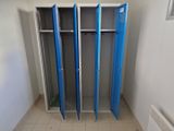 two blue lockers in the corner of a room