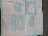 a tea towel with a picture of a cat on it on the floor