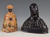 three ceramic figurines of a woman and a man on a table
