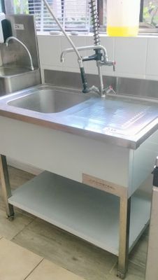 a stainless steel sink with a faucet in the middle