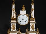 an image of a white and gold clock sitting on top of a table