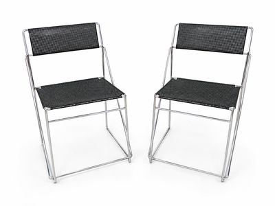 pair of black folding chairs on a white background with a white background