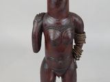 an old wooden statue of a man with a hat on his head