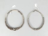 pair of silver hoop earrings with twisted ends on a white background