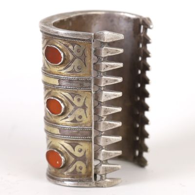 an image of a silver bracelet with red stones on a white background