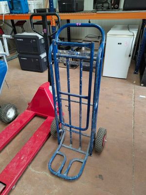 a blue hand truck and a red hand truck in a warehouse