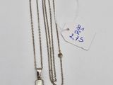 a close up of a cross on a chain with a price tag