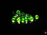 a close up of a bunch of green lights in the dark