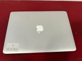 an apple macbook is sitting on top of a red table