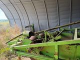 a large green machine that is sitting in the dirt
