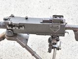 a machine gun that is sitting on a tripod