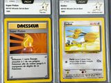 two pokemon trading cards are displayed in a plastic case