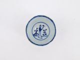a blue and white plate with a picture of a man and a woman on it