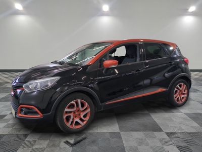 a black and orange car parked on a checkered floor