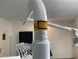 a white pipe with a yellow sticker on it in a room