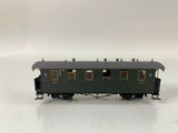 an image of a black train car with yellow windows on a white surface