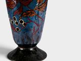 a blue vase with a floral design on it