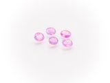 a group of three pink sapphires on a white background