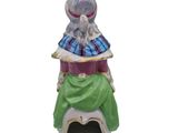 a figurine of a woman sitting on top of a chair