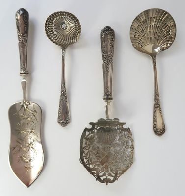 five spoons and two spoons on a white surface