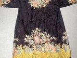 an image of a black and yellow dress with flowers on it