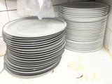 a stack of plates on a shelf in a kitchen
