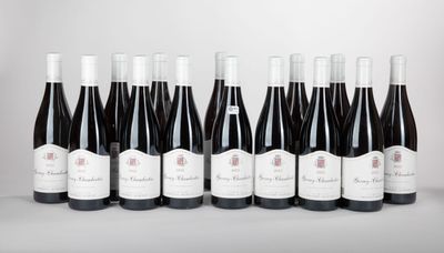 six bottles of wine lined up in a row on a table