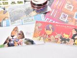a lot of postcards and a cup of beer on the table