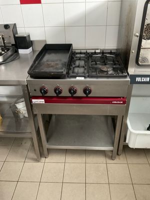 a kitchen with a stove, oven, and sink in it