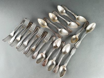 a lot of spoons and forks arranged together on a table