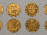 six different types of gold coins on a white surface