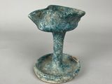 a small blue vase that is sitting on a table