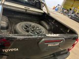 a truck that has a tire in the bed of it
