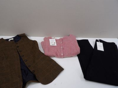 three pieces of clothing sitting on a white table